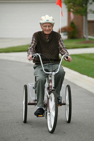 Senior on three wheel bicycle
